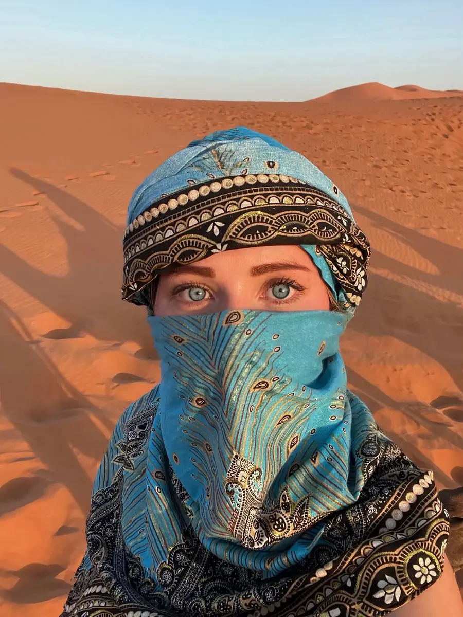 Local life in the Sahara Traveller wrapped in a blue desert scarf in the Sahara